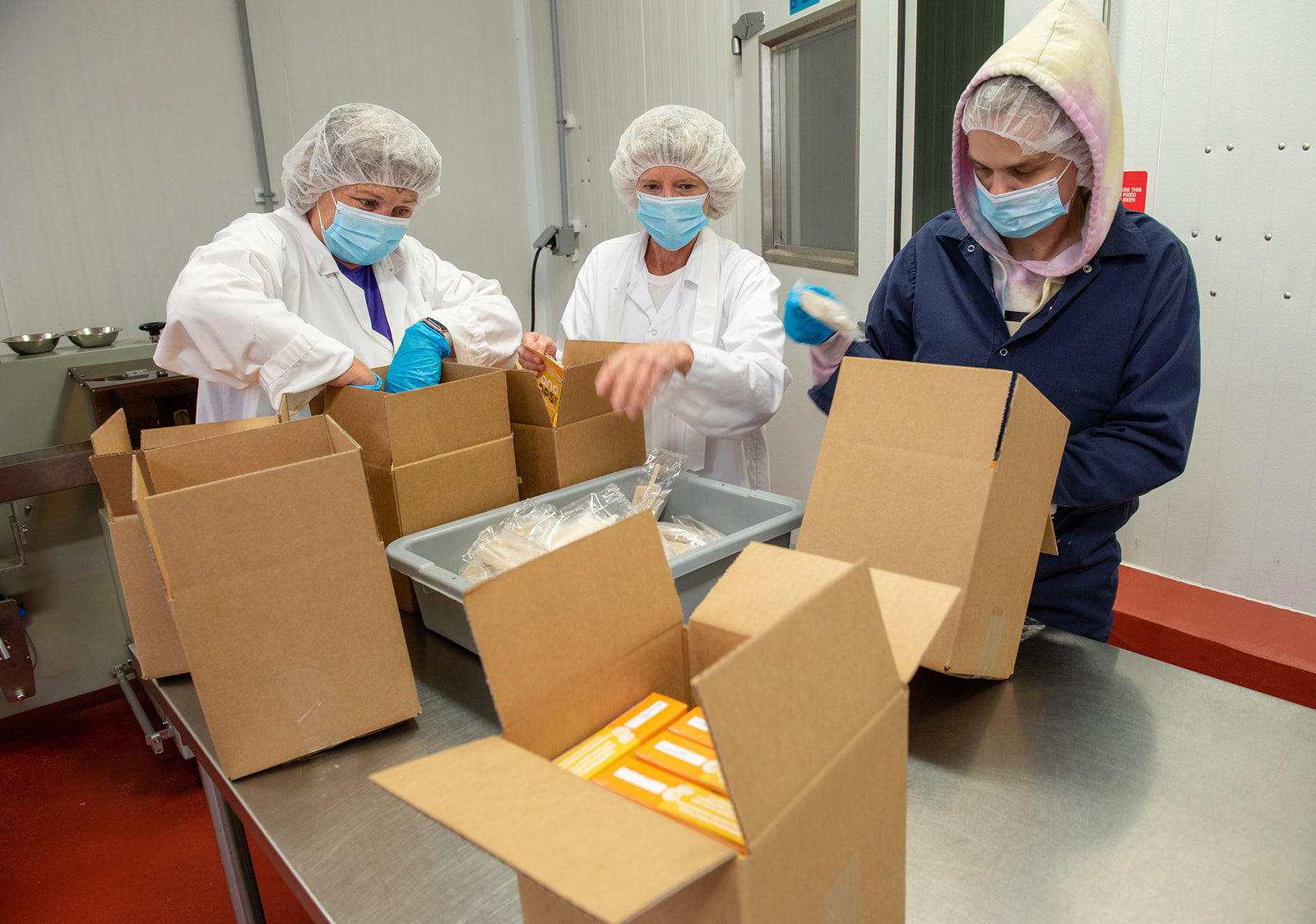 Staff pack food into boxes