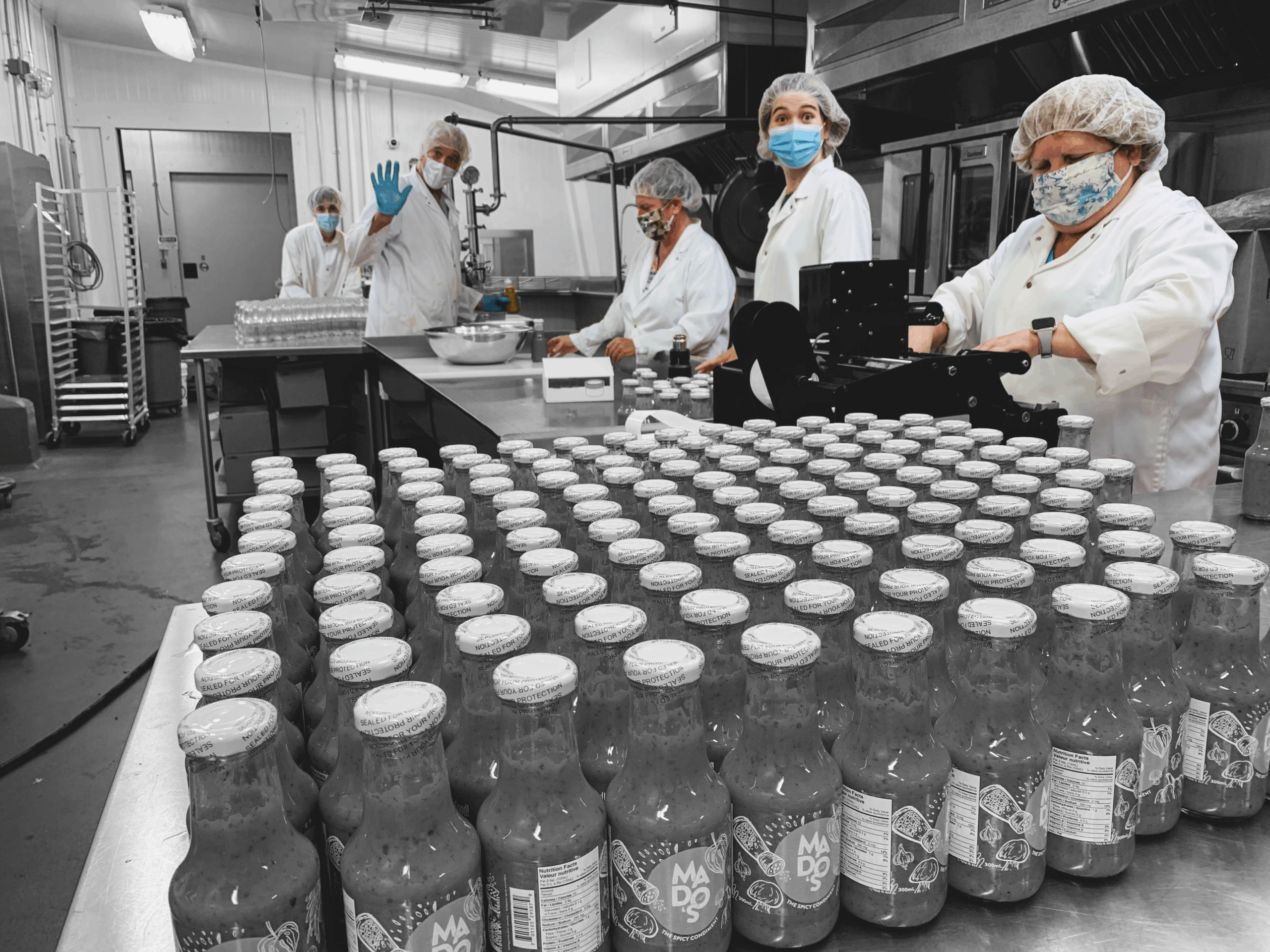 Staff processing bottled products in the OAFVC